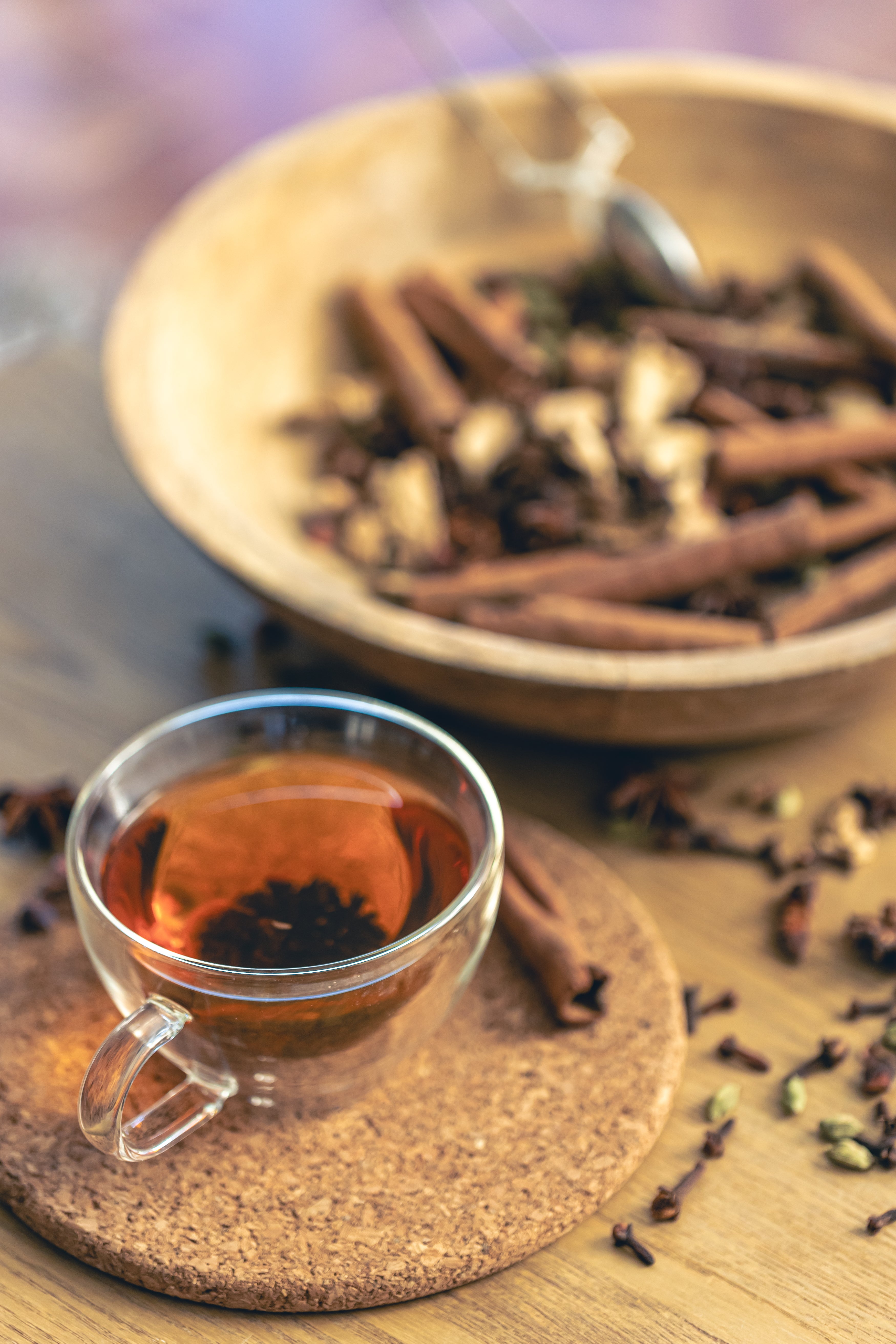 cup freshly brewed black tea different types spices wooden table