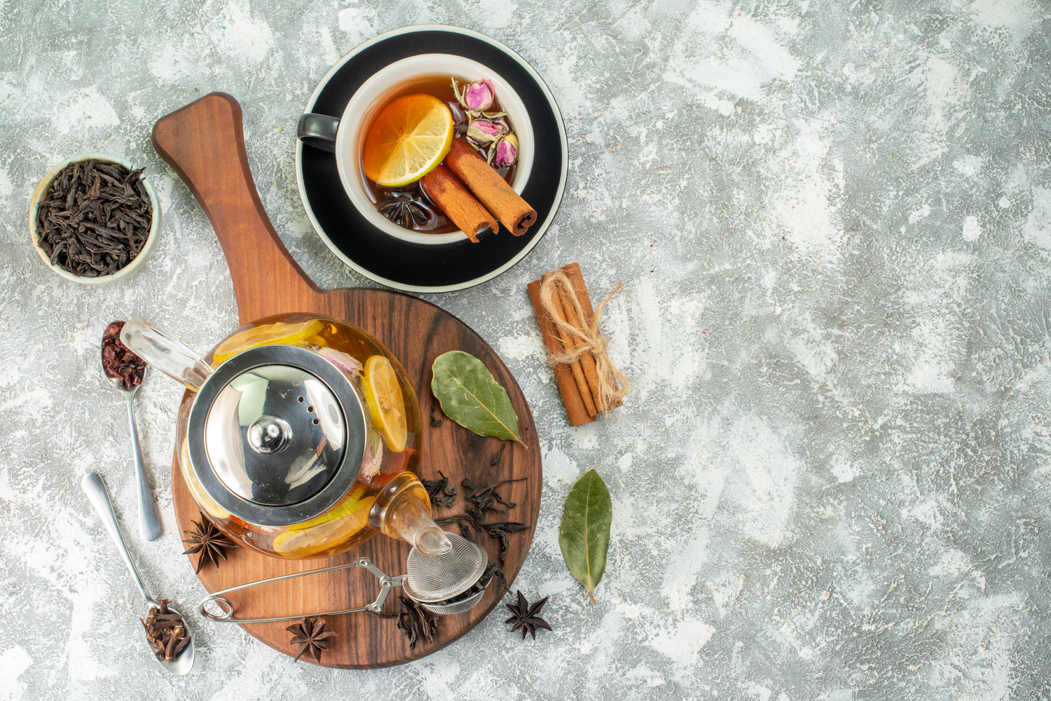 top-view-kettle-with-tea-lemon-tea-light-background-flower-color-morning-breakfast-food-fruit-flavor-ceremony